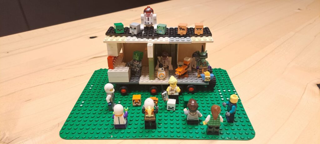 Nachbau eines Labors aus Lego-Steinen und -Figuren auf einer grünen Legoplatte.