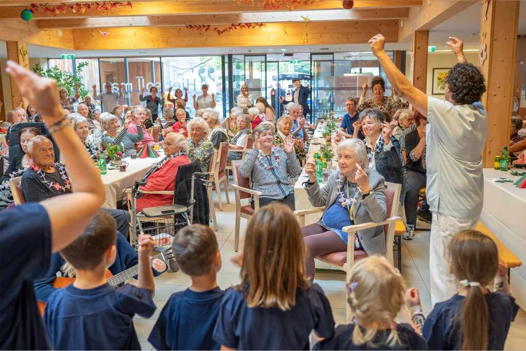 Bewohner:innen feiern bei der 10 Jahresfeier des Pflegewohnheims Erika Horn.
